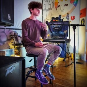 poet reading on stage at microphone
