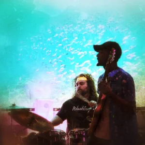 drummer and singer in front of projector screen